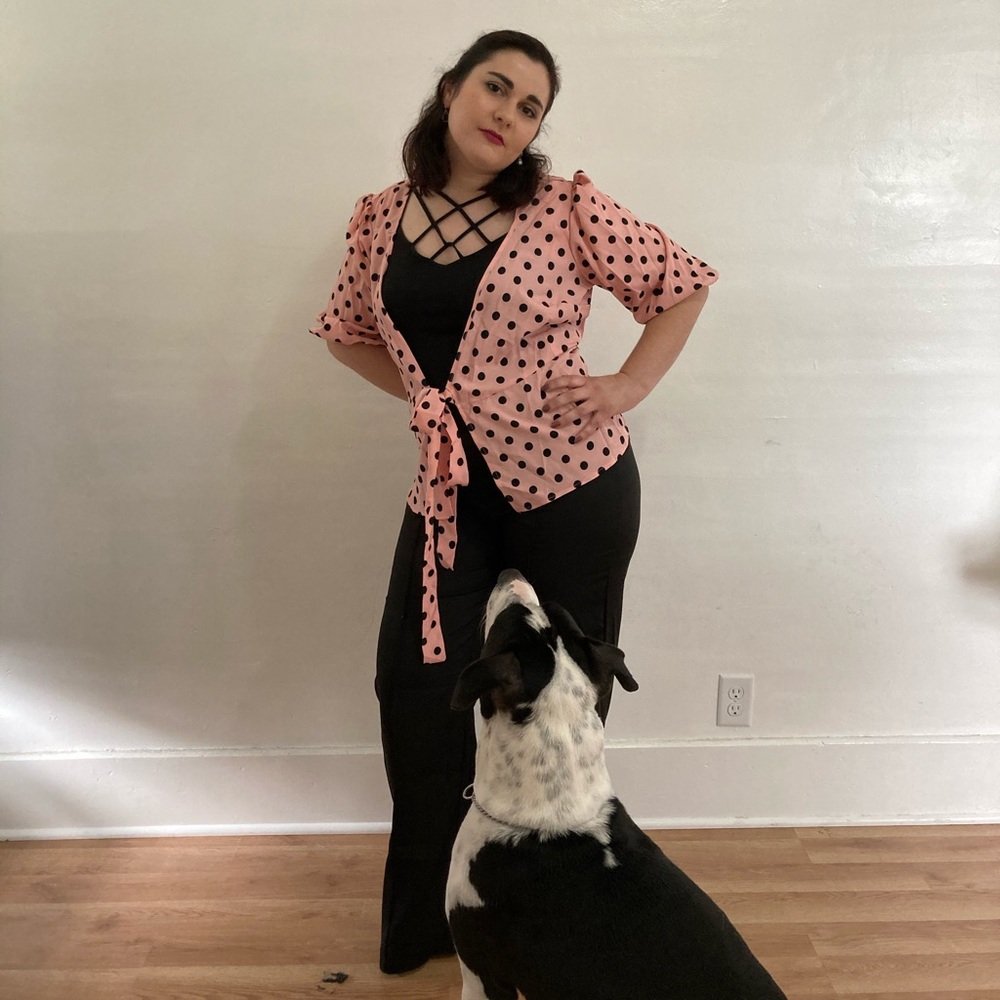Pink polka dot blouse/black flare bottom pants.